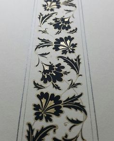 a white and black floral pattern on a wall