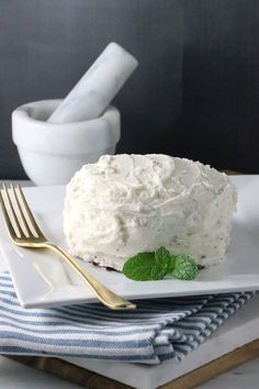 a piece of cake sitting on top of a white plate next to a knife and fork