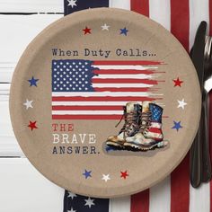 a paper plate with an american flag and combat boots on it next to a fork