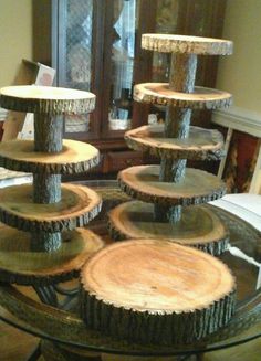 a glass table topped with lots of wood slices