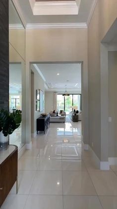 an empty hallway leading to a living room and dining room