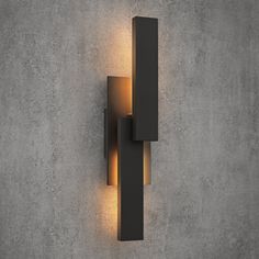 a wall mounted light on the side of a concrete wall