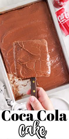 someone is holding a chocolate cake on a spatula with the words coca cola cake in front of it