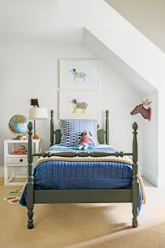 a child's bedroom with blue bedding and white walls