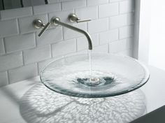 a bathroom sink with water running from it's faucet to the bowl