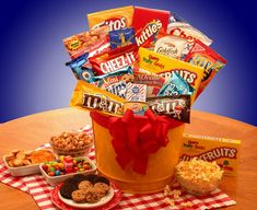 a large bucket filled with snacks on top of a table