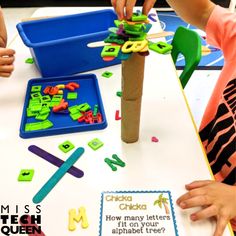 children are playing with letters and shapes on the table