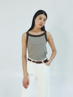 This is a trendy and modern top by MOHAN that is made out of high quality and sturdy material. With distinctive mood of the design and comfortable wear, you can style it for your casual daily outfit.- Fabric with high elasticity- Clean and casual stripe pattern overall- Minimal and feminine mood Chic Cotton Tops With Contrast Stripes, Trendy Striped Vest For Spring, Trendy Striped Stretch Tank Top, Chic Striped Spring Vest, Chic Striped Summer Vest, Casual White Tank Top With Contrast Stripes, Cotton Sleeveless Tank Top With Contrast Stripes, Sleeveless Cotton Tank Top With Contrast Stripes, Chic Vertical Stripes Tops For Summer