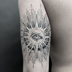 a man's arm with an all seeing eye tattoo on the upper half of his arm