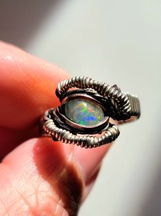 Nice flashy ethiopian opal made with mixed metals (copper and argentiun silver). Symmetrical design with angles and some curves... and a nice little twist... Comes in a ring box and with a polishing cloth Please see all photos as they are considered part of the description Handmade Silver Rings With Ethiopian Opal, Handmade Silver Ethiopian Opal Rings, Unique Ethiopian Opal Ring, Unique Handmade Ethiopian Opal Ring, Unique Silver Ethiopian Opal Ring, Unique Opal Ring For Jewelry Making, Symmetrical Design, Argentium Silver, Wire Wrapped Rings