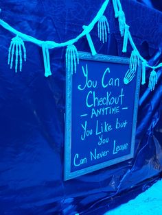 a blue tent with a sign that says you can check out anytime you like but can never leave