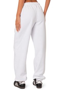 A cozy cotton blend keeps you feeling your best no matter what the day brings when you choose these oversized sweatpants. Elastic waist Side-seam pockets Elastic cuffs 50% cotton, 50% polyester Machine wash, dry flat Imported Casual White Sweats For Leisure, Basic Cotton Sweats For Lounging, Comfortable White Baggy Bottoms, Baggy White Leisure Pants, Baggy White Pants For Leisure, White Baggy Leisure Pants, Comfortable Baggy White Pants, Relaxed White Bottoms With Pockets, Oversized Cotton Joggers