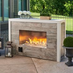 an outdoor fireplace in the middle of a patio