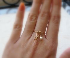 Beautiful handcrafted dainty ring made with 14k Gold Filled Wire, combined with a small gold filled starfish charm and tiny pearl. All sizes available, please select one from the drop down list. For more dainty rings please visit: https://www.etsy.com/shop/Lalinne?section_id=12651472 Kim Walker, Kpop Closet, Starfish Ring, Beach Rings, Wire Jewelry Rings, Dainty Rings, Stella Marina, Ring Pearl, Charm Ring