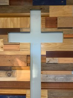 a cross made out of wooden planks on the wall