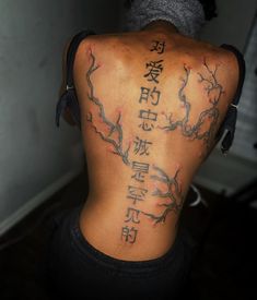 the back of a woman's body with chinese writing on her upper and lower back