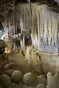 an ice cave with icicles hanging from the ceiling