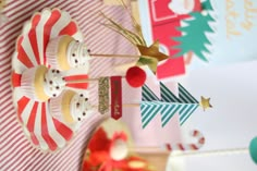 some cupcakes are on a red and white striped plate with trees in the middle