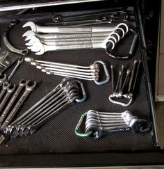 there are many wrenches and other tools in the case