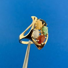 * Vintage 14K Yellow Gold Multi Gemstone Modernist Twist Cocktail Finger Ring * Ring Size: 4.0 * Top of ring measures: 1.0" x 1/2" * Height: 1/2" * Band width: 2.0 mm * Jadeite oval cabochon measures approximately 5.50 mm x 4.0 mm * Jasper oval cabochon measures approximately 5.50 mm x 4.0 mm * Agate oval cabochon measures approximately 5.50 mm x 4.0 mm * Carnelian oval cabochon measures approximately 5.50 mm x 4.0 mm * Black Onyx oval cabochon measures approximately 5.50 mm x 4.0 mm * Ring weight: 4.5 tgw * Marked: 14K * Condition: Great, as pictured. * G2485 5% Restocking Fee    Exported By ExportYourStore :) Modern Multi-stone Rings, Elegant Multicolor Cabochon Rings, Yellow Gold Multi-stone Art Deco Jewelry, Hallmarked Multicolor 14k Gold Rings, Oval Gemstone Rings In Modernist Style, Modern 14k Gold Multi-stone Jewelry, Modern 14k Gold Opal Gemstone Ring, 14k Gold Multi-stone Round Gemstones, Modernist Oval Gemstone Rings