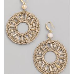 two pairs of gold toned earrings with white beads and filigrees on them