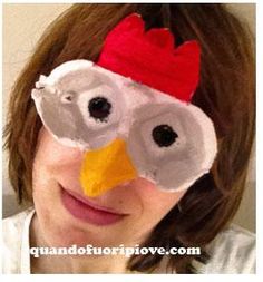 a woman wearing a paper mache chicken mask with googly eyes and a red headband