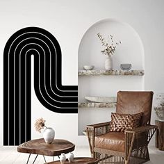 a living room filled with furniture and walls painted in black and white stripes on the wall