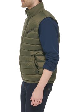 Update your cold-weather collection with this quilted puffer vest that's a versatile must-have layering piece. 26.5" length (Size M) Stand collar Sleeveless Zip front Slanted zipper chest pocket 100% nylon Machine wash cold Imported Model stats: 6'1" height, 32" waist. Model is wearing size M. Spring Quilted Puffer Jacket For Outdoor Activities, Casual Winter Vest With Zipper Closure, Quilted Vest For Cold Weather, Casual Nylon Quilted Jacket, Casual Nylon Quilted Jacket With Padded Collar, Casual Down Quilted Jacket For Spring, Casual Nylon Vest With Zipper Closure, Quilted Down Sleeveless Outerwear, Casual Nylon Vest With Padded Collar