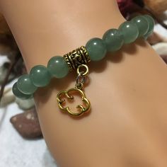 "Embrace the soothing energy of nature with our Green Aventurine Rainy Day Cloud Charm bracelet. Handcrafted with love, this green jewelry piece showcases the mesmerizing beauty of green aventurine beads. Each bead represents the refreshing essence of a rainy day, while the cloud charm adds a touch of whimsy. Wear this beaded bracelet and let its calming vibes uplift your spirit, making rainy days nothing short of magical. Perfect for any nature lover or someone special. PRODUCT DETAILS - Natural green aventurine cloud charm bracelet - 8mm aventurine natural gemstone beads - Antique gold cloud charm - Antique gold bail tube charm holder and spacer - Strong, stretchy cord - Handmade in a clean and safe environment CONTACT US: Do you have any questions, wishes, or want to give us your feedba Green Gemstone Bracelets For Meditation, Green Gemstone Meditation Bracelets, Green Amazonite Bracelet, Holistic Green Bracelets With Gemstone Beads, Green Amazonite Beaded Bracelets As Gift, Green Gemstone Crystal Bracelet For Meditation, Holistic Jade Beaded Bracelets As Gift, Round Aventurine Bracelets For Gifts, Aventurine Round Bracelet Gift