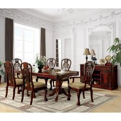 a dining room table with chairs and a china cabinet