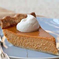 a slice of pumpkin pie with whipped cream on top