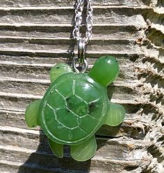 This smaller sized Canadian Jade Turtle pendant measures approximately 20mm in size. This pendant will come with or without a Sterling silver chain and will come complete with a hand crafted wooden gift box. All of our Jade is 100% natural. Turtles symbolize good health and long life.  View other products from JademineCanada here : https://www.etsy.com/ca/shop/JadeMineCanada?ref=hdr_shop_menu ** All purchases from outside of Canada are subject to duties and VAT fee's ------ Jade West has been mi Green Resin Pendant Necklace, Small Handmade Green Jewelry, Handmade Small Green Jewelry, Green Resin Round Pendant Necklace, Green Engraved Round Pendant Necklace, Jade West, Turtle Pendant, Wooden Gift Boxes, Nephrite Jade