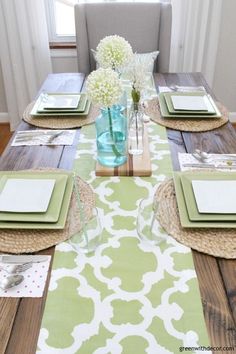 the table is set with place settings for four people to sit down and have their plates laid out