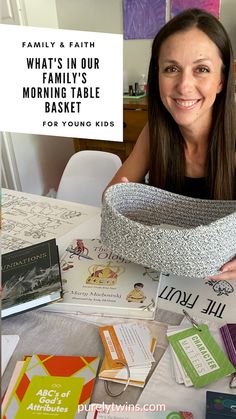 a woman sitting at a table with lots of books on it and a basket over her head