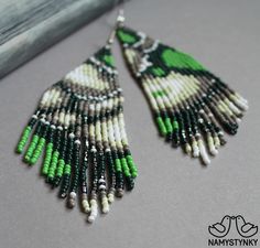 These abstract green beaded earrings are made of high-quality Czech beads and strong synthetic thread. They are elegant, fashionable, and highly versatile, suitable for everyday wear. Features: Sterling silver components Color: Black, gray, white, green, silver. This item is currently in stock. More beaded earrings http://etsy.me/2ycItdb Gerdan necklaces http://etsy.me/2mihf0J Beaded necklaces http://etsy.me/2Dkf1Fo Crochet necklaces http://etsy.me/2CAPdFc Back to shop https://www.etsy.com/shop/ Green Bohemian Chandelier Earrings With Dangling Beads, Green Bohemian Beaded Earrings With Tiny Beads, Bohemian Green Chandelier Earrings With Ear Wire, Green Bohemian Chandelier Earrings With Colorful Beads, Bohemian Green Chandelier Earrings With Colorful Beads, Green Bohemian Earrings With Colorful Beads, Bohemian Green Beaded Earrings With Colorful Beads, Bohemian Green Earrings With Colorful Beads, Green Bohemian Beaded Dangle Earrings