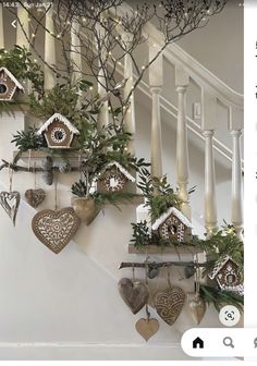 a bunch of ornaments are hanging on the wall next to some banisters and stairs