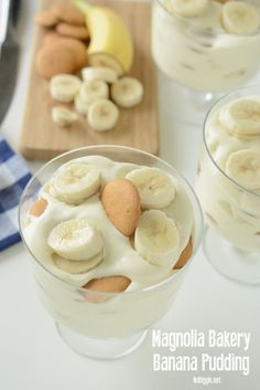 banana pudding with whipped cream and sliced bananas in the middle on a cutting board next to other desserts