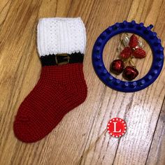 a red white and blue christmas stocking next to a small toy ornament