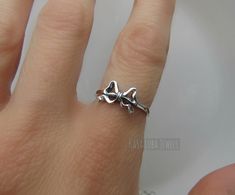 Sterling Silver Bow ring, promise ring, ribbon ring - stamped 925 - womens rings - sweet ring - cute ring *IF YOUR SIZE ISNT SHOWING, MESSAGE ME. I might be sold out and will be able to replenish shortly* TARNISH FREE Face Height: 8 mm Metal Material: Sterling Silver Finish: Oxidized Stamped 925 Nothing but the best from my custom jewelry store. Email me if you have any questions. Cute Silver Rings For Gift, Cute Silver Rings For Anniversary, Cute Open Ring For Promise, Cute Silver Open Ring, Cute Anniversary Jewelry With Bow, Cute Adjustable Rings For Promise, Cute Adjustable Promise Ring, Round Bow Rings For Gift, Adjustable Anniversary Ring With Bow Detail