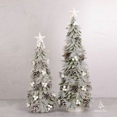 two small christmas trees sitting next to each other