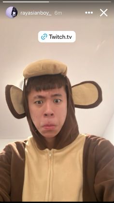 a man wearing a monkey costume on his head and looking at the camera with an emoticive expression