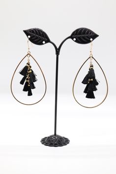 Gold Teardrop Earrings with Black Tassels boast a striking design, featuring a shiny gold teardrop-shaped base from which flow lush black tassels. The contrast between the gold and black adds a modern and elegant flair, making these earrings a standout accessory for any occasion. Gold Teardrop Earrings, The Gold, Christmas Sale, Teardrop Earrings, Rainbow Colors, Lush, Tassels, Gemstones, Crystals