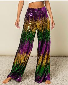 a woman wearing purple and green sequin pants