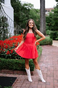 This bold and vibrant red mini dress features playful shoulder tie spaghetti straps and a flattering square neckline. The zipper closure back allows for easy dressing, while the drop waist and pleated skirt add a touch of fun and movement. Perfect for a night out or special occasion. 80% polyester, 20% cotton Fully lined Model is 5'5" and a size 2 - wearing a small Size rec: 0-2 S, 4-6 M, 8 L Bama Rush, Tailgate Outfits, Football Tailgate Outfit, Gameday Fits, College Gameday Outfits, Gameday Outfits, Loungewear Summer, Pleated Mini Dress, Easy Dressing