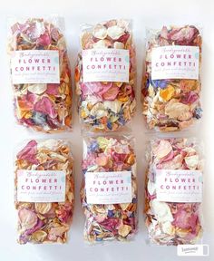 four bags of flower confetti sitting on top of each other