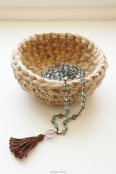 a small bowl with beads and a tassel