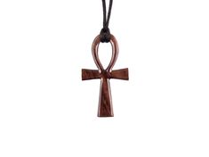 "This reversible large wooden Ankh pendant is artfully hand carved Bolivian Rosewood, an exotic hardwood that is highly diverse in patterns, making this wearable art pendant unique and one of a kind. Depending of one's display the color of the pendant may vary slightly. - The pendant measures approximately 2.5\" (6.3cm) tall by 1.4\" (3.5cm) wide. - This pendant comes with a 30\" (78cm) black satin cord that you can tie yourself as short or as long as you would like, ready to wear. We have more Symbolic Brown Pendant Necklace, Spiritual Brown Carved Necklace, Cross Necklace Mens, Crow Pendant, Ankh Pendant, Egyptian Ankh, Ankh Necklace, Ankh Cross, Raven Necklace