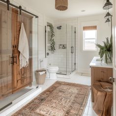 a bathroom with a rug, sink and shower in it's centerpieces