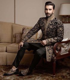 a man sitting on top of a couch in a living room