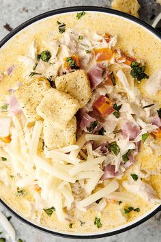 a bowl filled with chicken, cheese and broccoli on top of a table